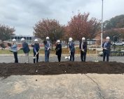 Special guests from CTECS, DAS, GreenBank and Verogy stand with shovels behind the ceremonial pile of dirt.